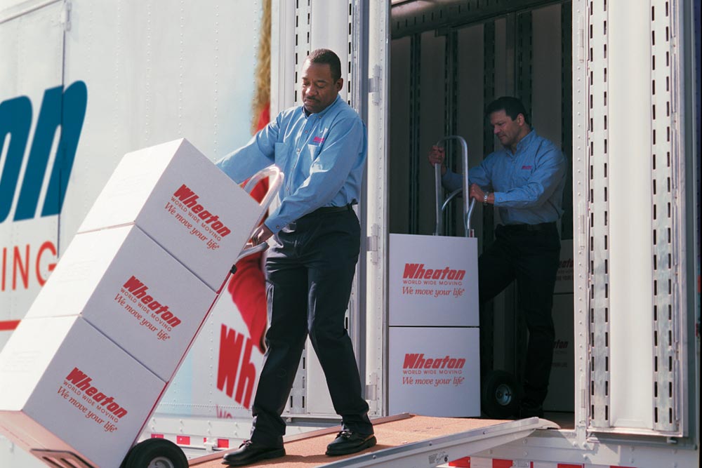 Two workers loading up a moving truck